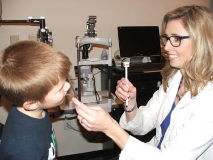 Photo of Dr. Kramer with a child patient